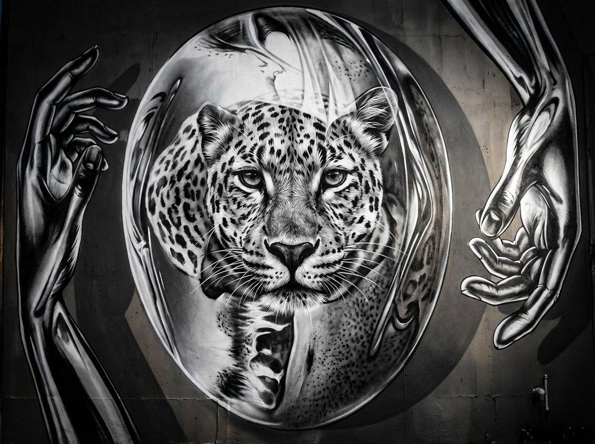 Large black and white leopard mural on the exterior wall behind Poe's Tavern in Atlantic Beach Florida