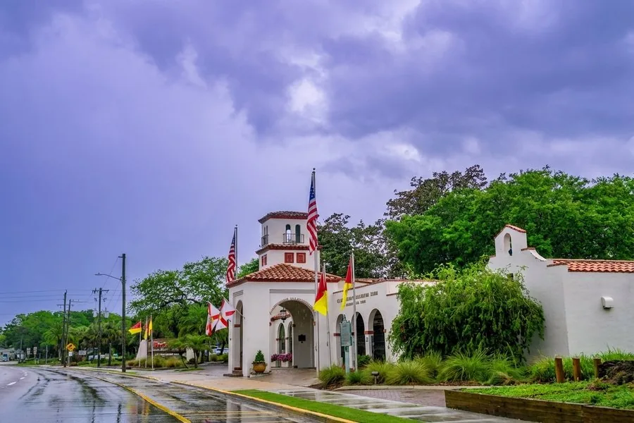 St. Augustine Alligator Farm entrance building with Spanish-style architecture under stormy skies