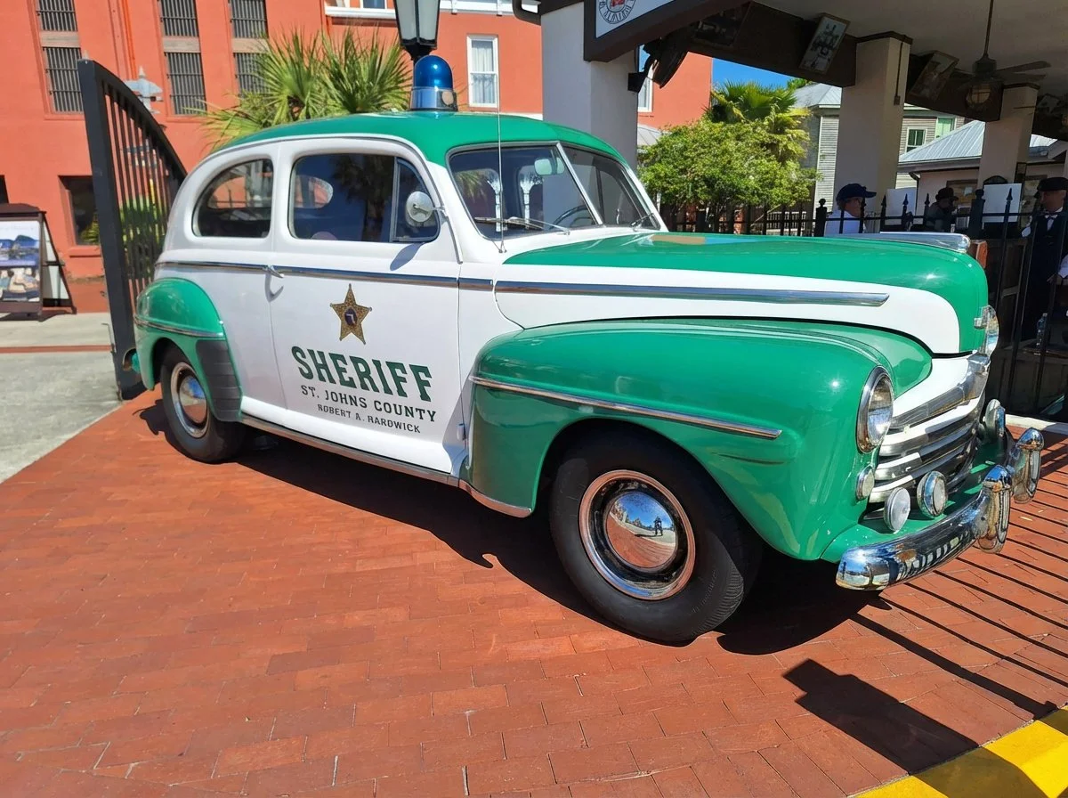 Vintage 1940s St. Johns County Sheriff patrol car in green and white at Old Town St. Augustine
