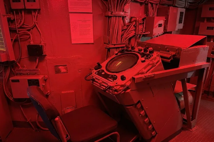 Combat Information Center aboard the USS Orleck — red-lit naval operations room